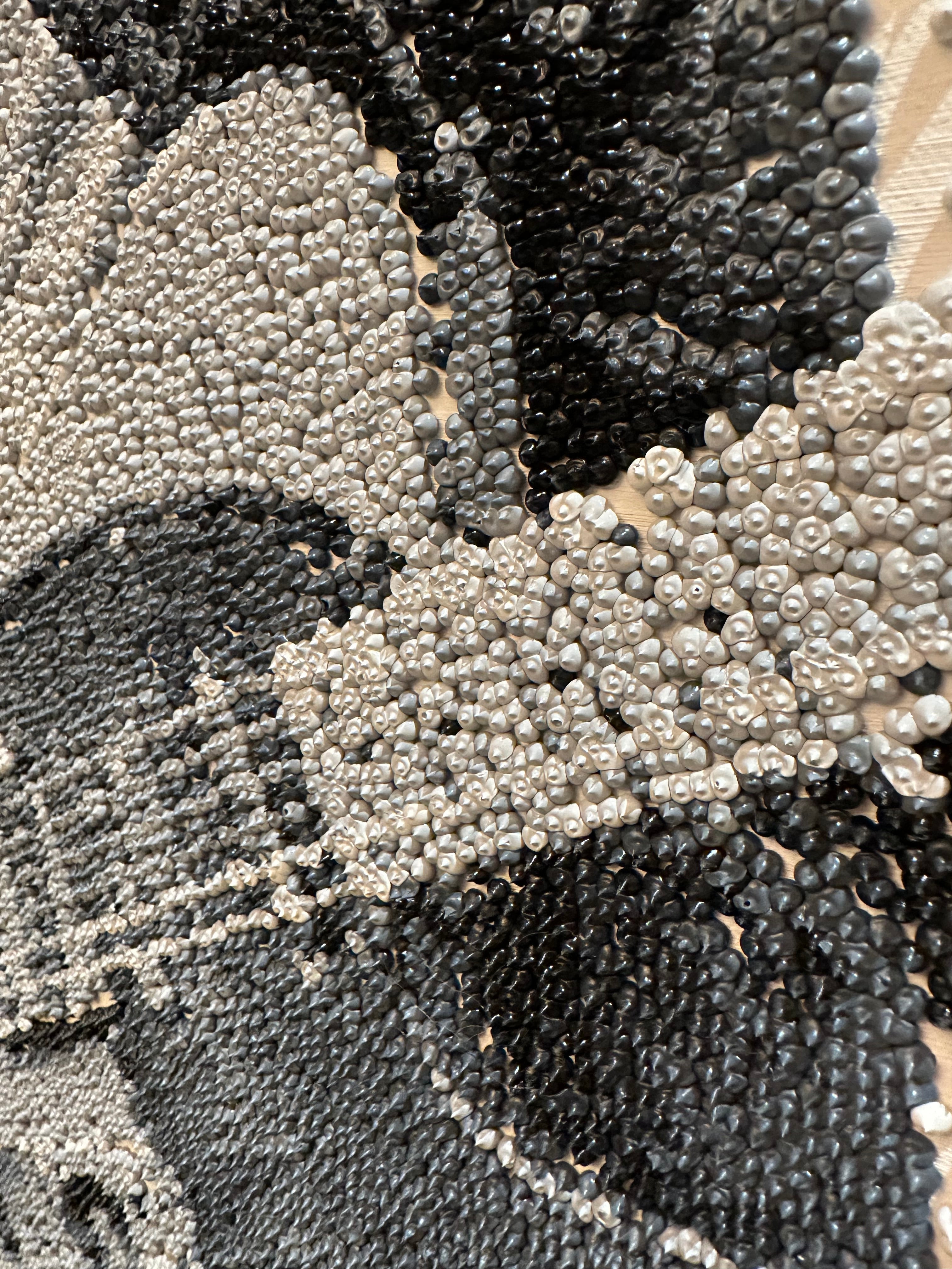 Close-up of a textured surface with black, gray, and white patterns
