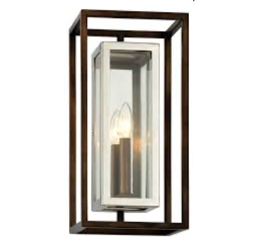 Troy Lighting wall sconce with glass cover on a white background