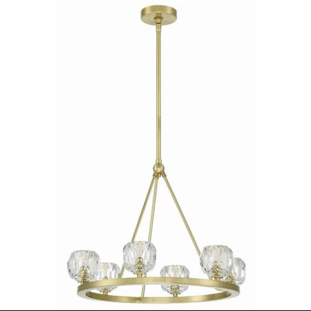 Gold chandelier with crystal shades on a white background, featuring Crystorama branding.