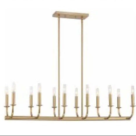 Gold island pendant light with multiple candles on a white background